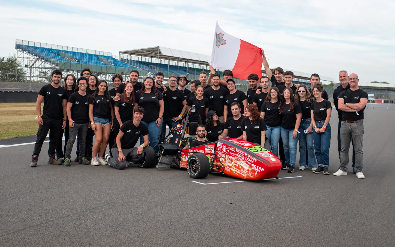 UM Racing students with the University of Malta’s EV26 electric Formula Student car at Silverstone