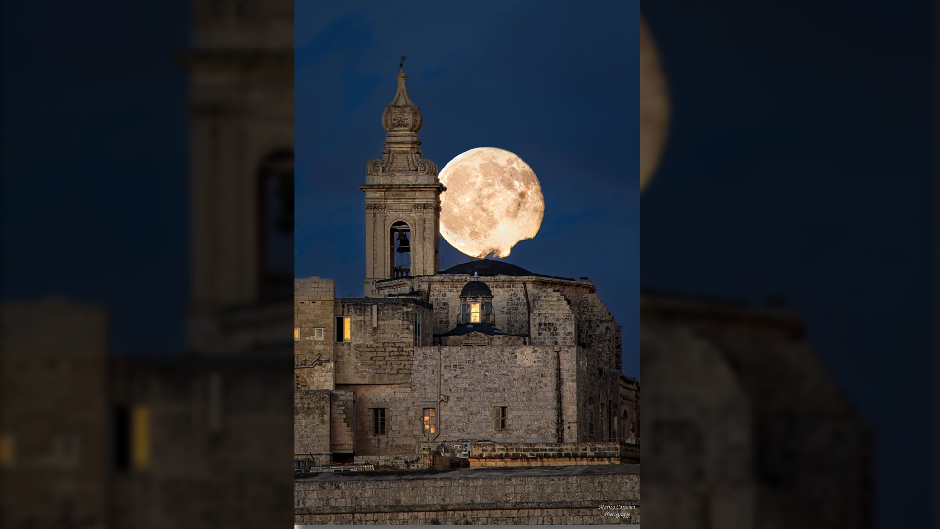 Almost Full Moon Appears Between Mdina’s Carmelite Church Spire and Dome
